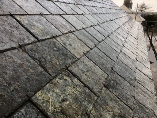 Close-up of a slate roof with textured tiles arranged diagonally.